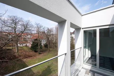 the terrace of a home with the view to a private park